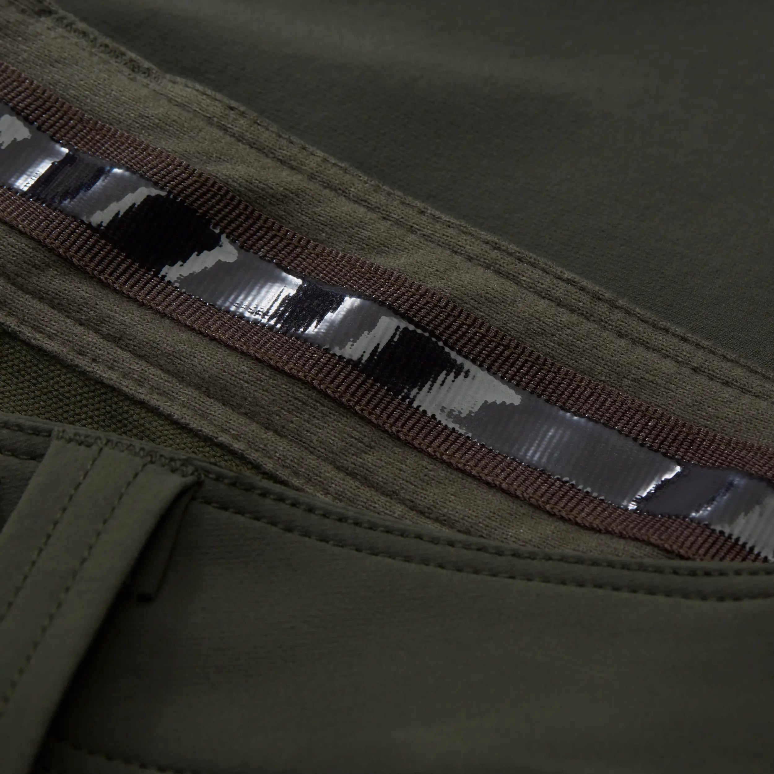 Close-up of rubber material waistband on green pant. #cypress