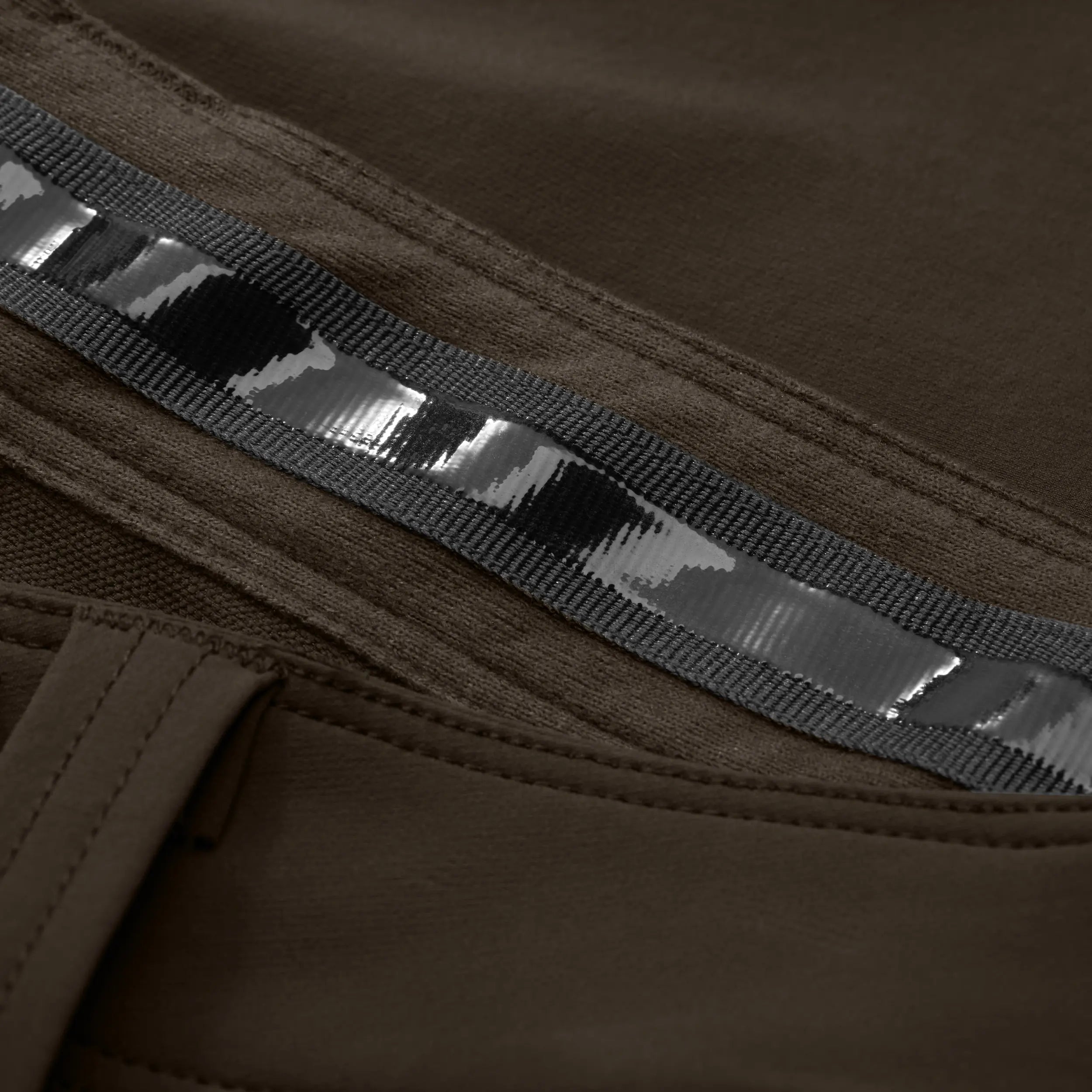 Close-up of rubber material waistband on brown pant. #mud