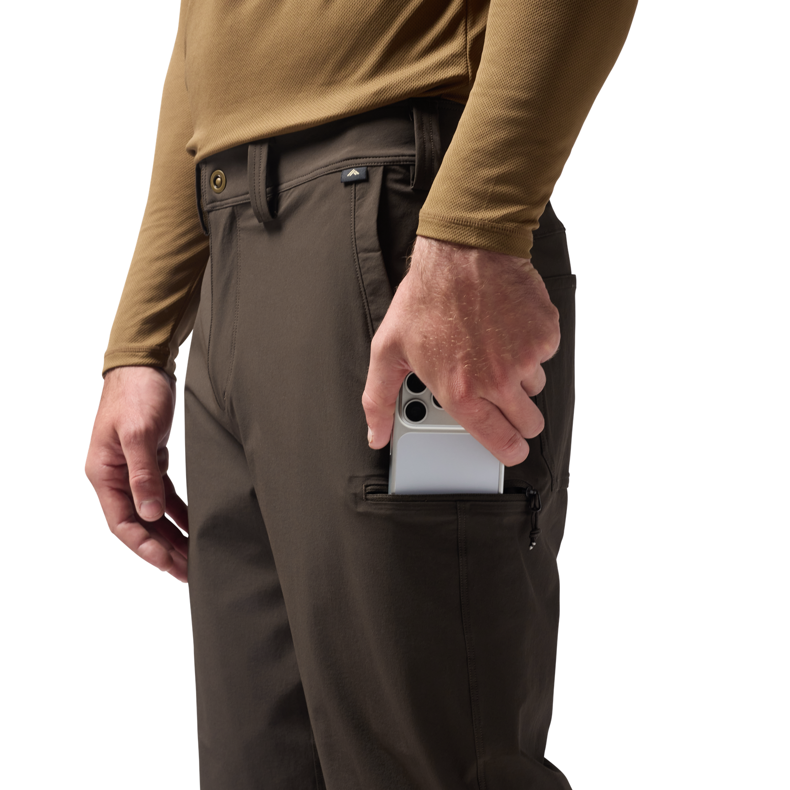 Person wearing brown pants with a camouflage shirt, holding a phone in a pocket. #mud