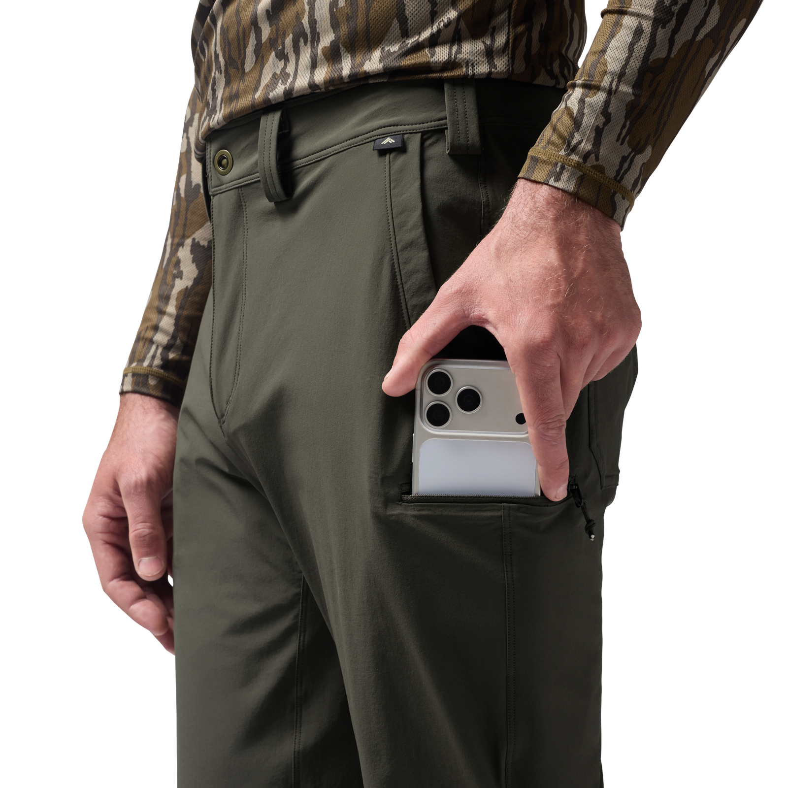 Person wearing green pants with a camouflage shirt, holding a phone in a pocket. #cypress
