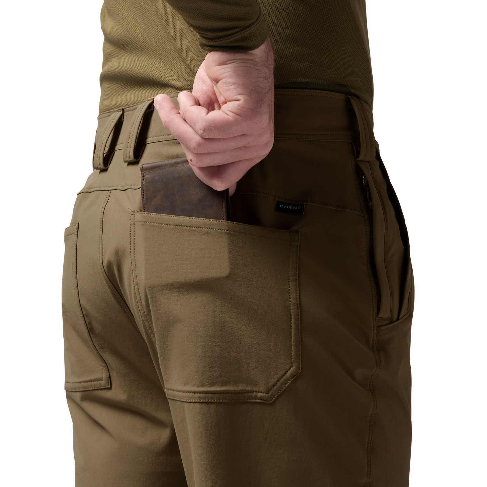 Person wearing tan pants with a brown leather wallet in a pocket, olive green shirt visible. #field_khaki