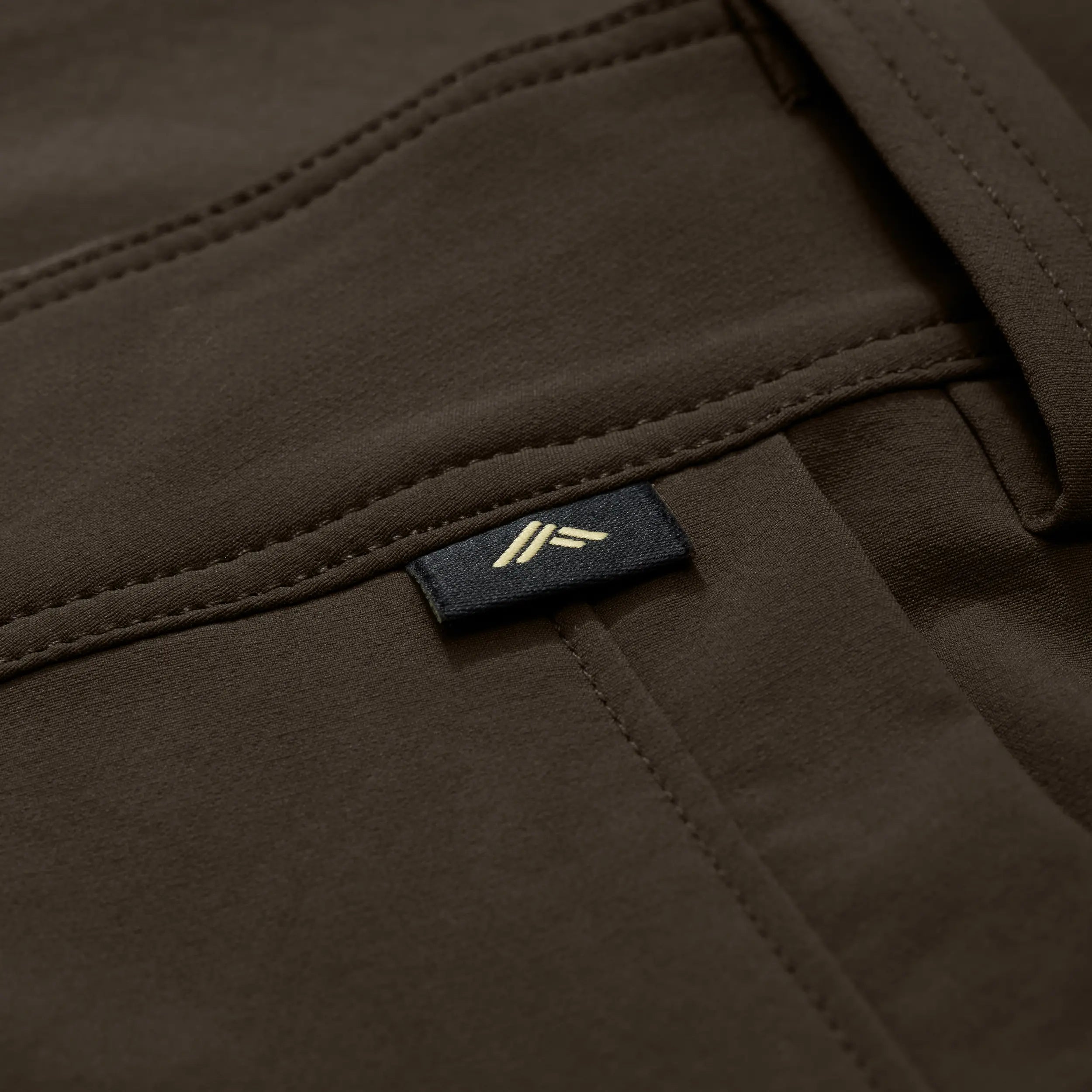 Chêne logo tag on brown pant. #mud