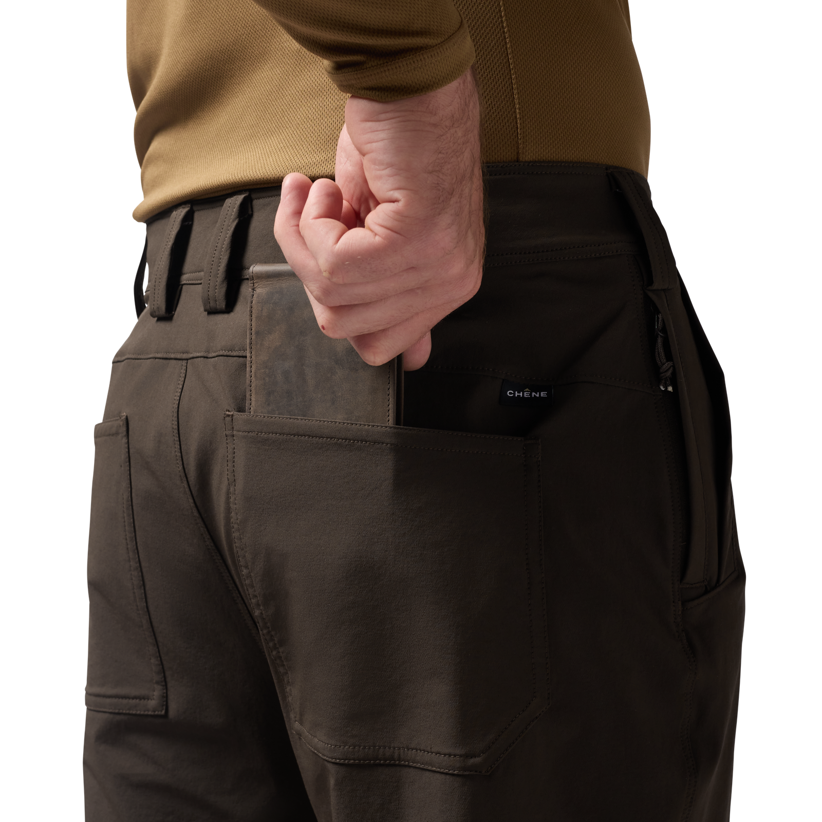 Person wearing brown pants with a brown leather wallet in a pocket, tan shirt visible. #mud